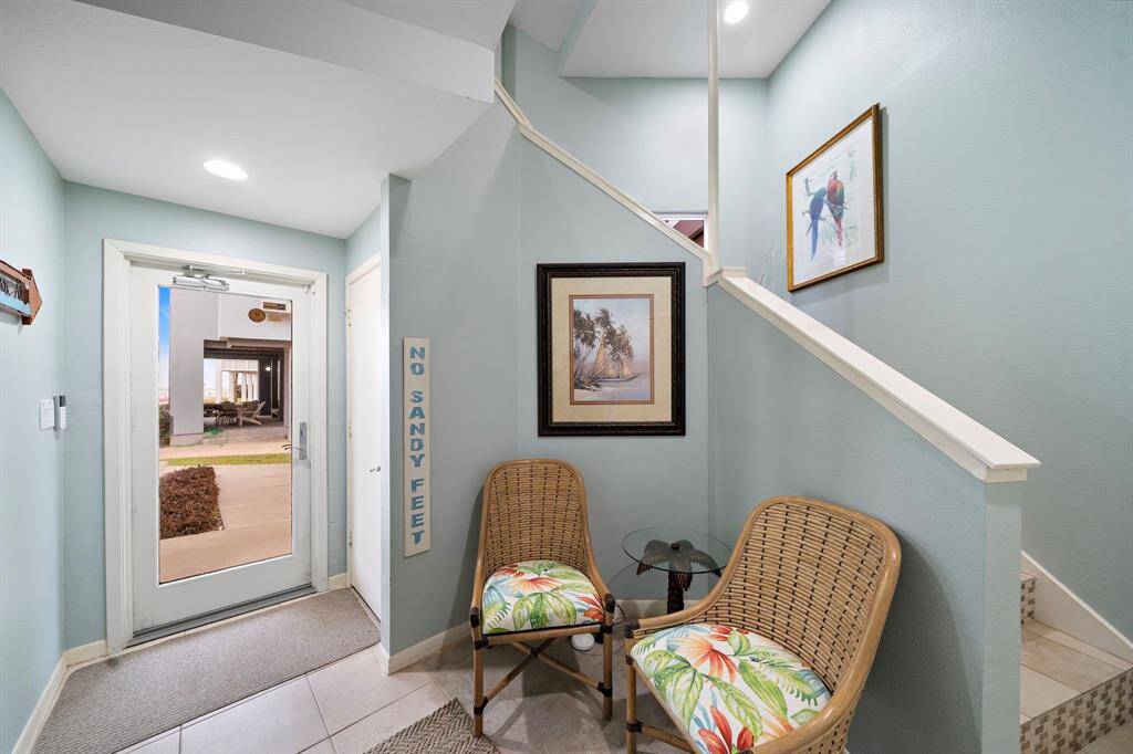 Ground floor entry offers space for a seating area, closet under the stairs, and elevator access.  (Table and chairs are excluded).