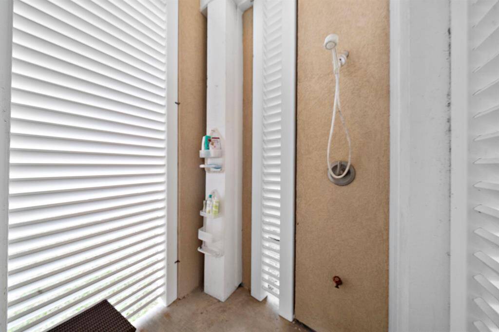 Outdoor shower and changing area on ground floor.