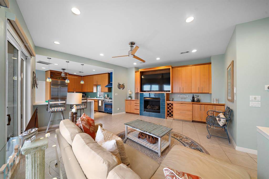 Another angle showing the entertaining space.  Recessed lighting throughout and glass pendants over the bar.