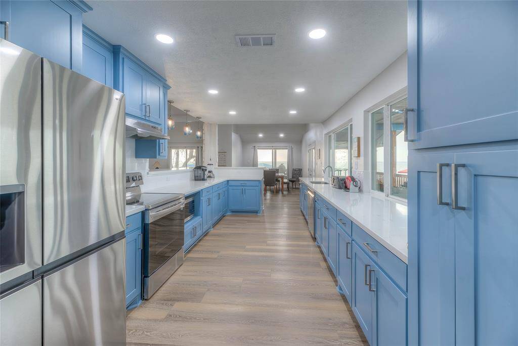 Galley style kitchen with beautiful, quartz countertops with ample storage and all with a million dollar view!