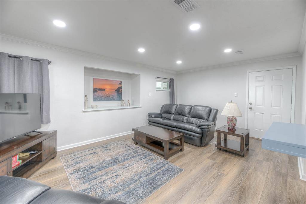 2nd living area with a TV and couches for relaxing along with plenty of windows to see the lakeview and pool