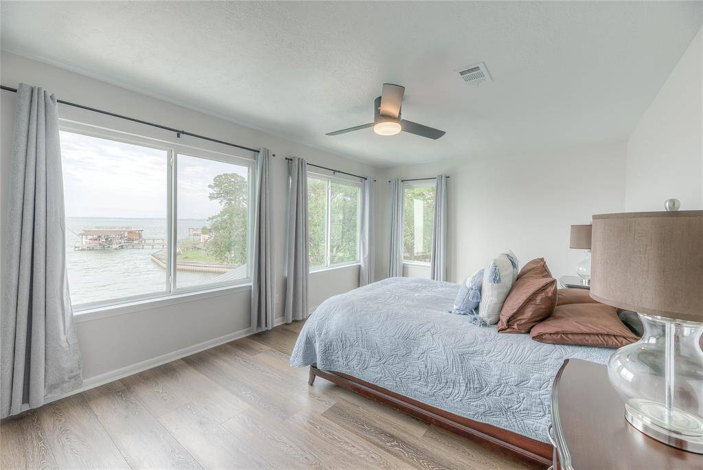 3rd beautiful bedroom on 2nd floor with a gorgeous view of the lake & the resort style infinity pool.
