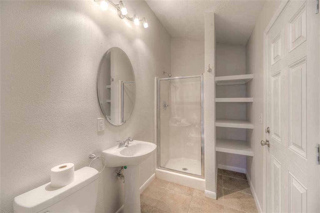 Pool house bath with shower, pedestal sink and commode.