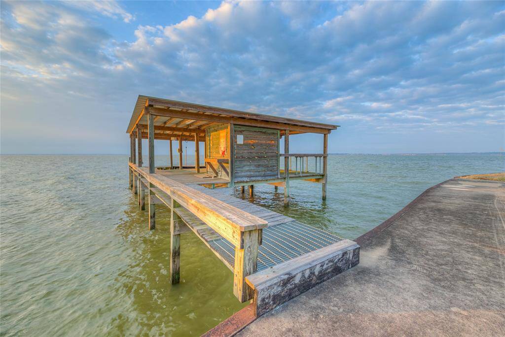 Boathouse with fishing piers, boat lift & 2 jet-ski lifts.