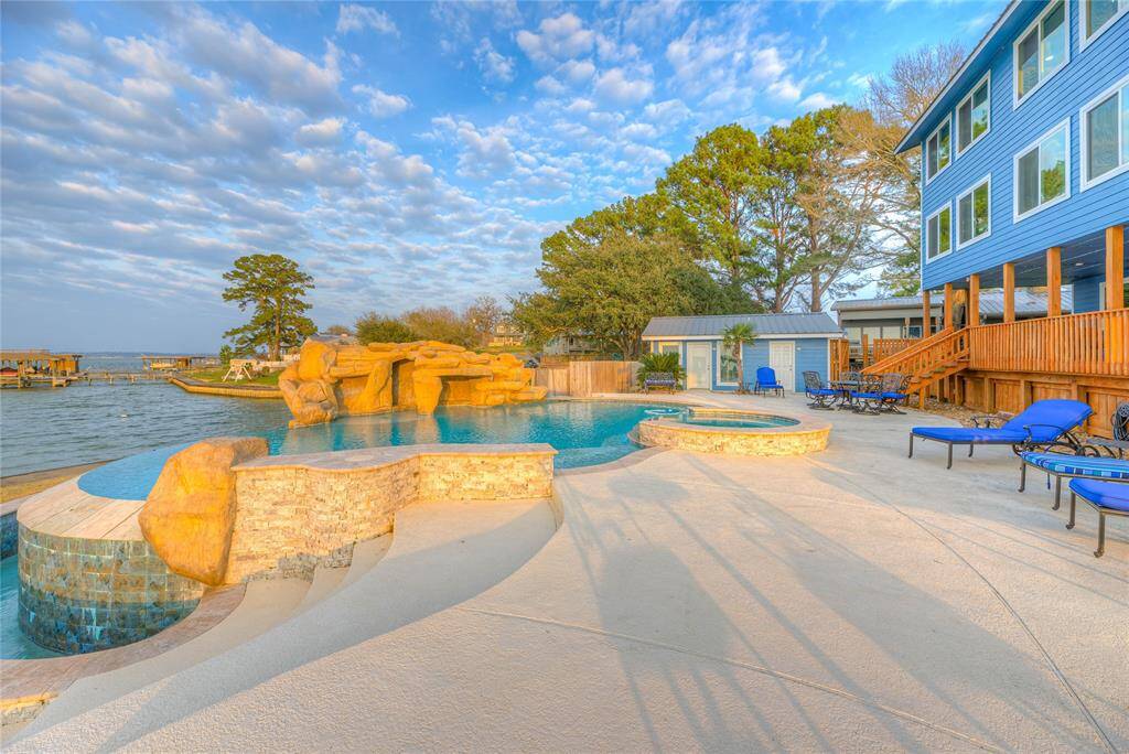 Beautiful rock waterfall, infinity edge pool with a hottub.