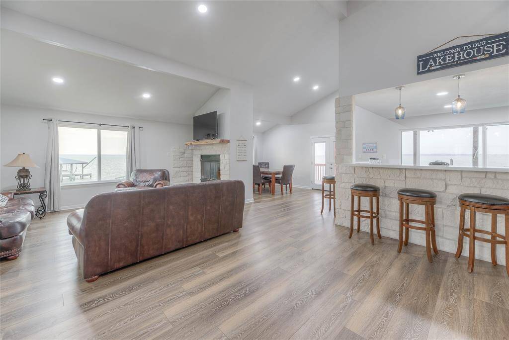 Upon entry you are greeted by the open concept living, dining & kitchen with a million dollar view of the lake from every window