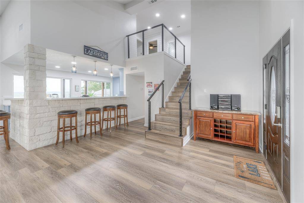 Beautiful, high soaring ceilings in the living room with beautiful lake views, along with a gorgeous quartz breakfast bar.
