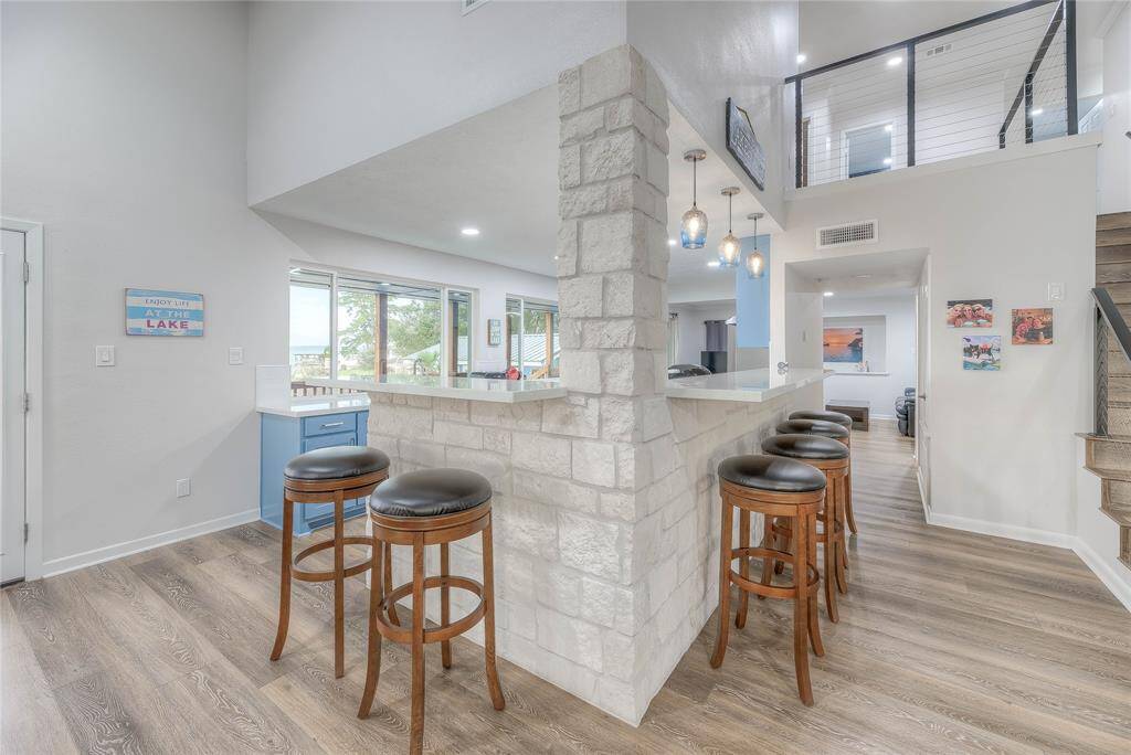 The beautiful white stone breakfast/snack bar topped with beautiful quartz will seat up to 6 with lake views as well.