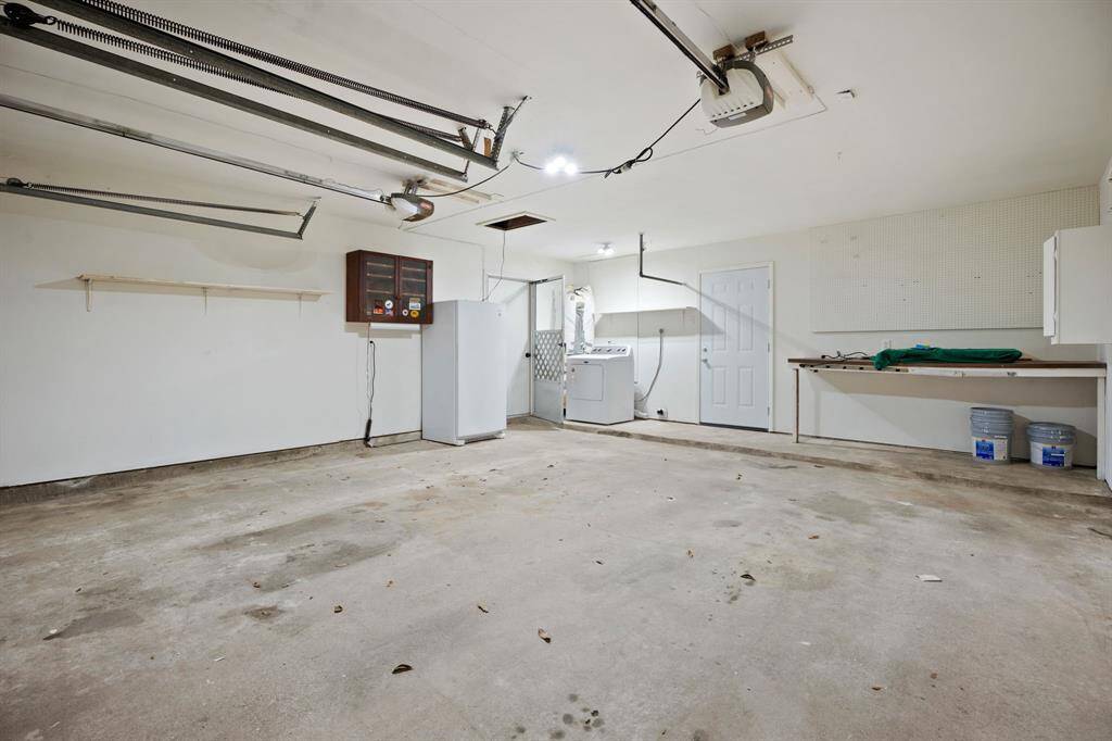 This roomy garage fits two cars and comes with a workbench, laundry space, and a garage door opener.