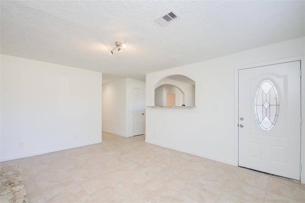 View of second entrance into second downstairs living area with fireplace. Looking into kitchen area