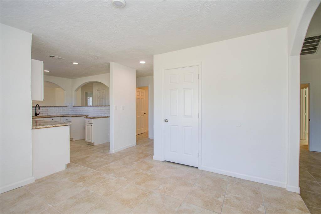 View of dining room and kitchen area.