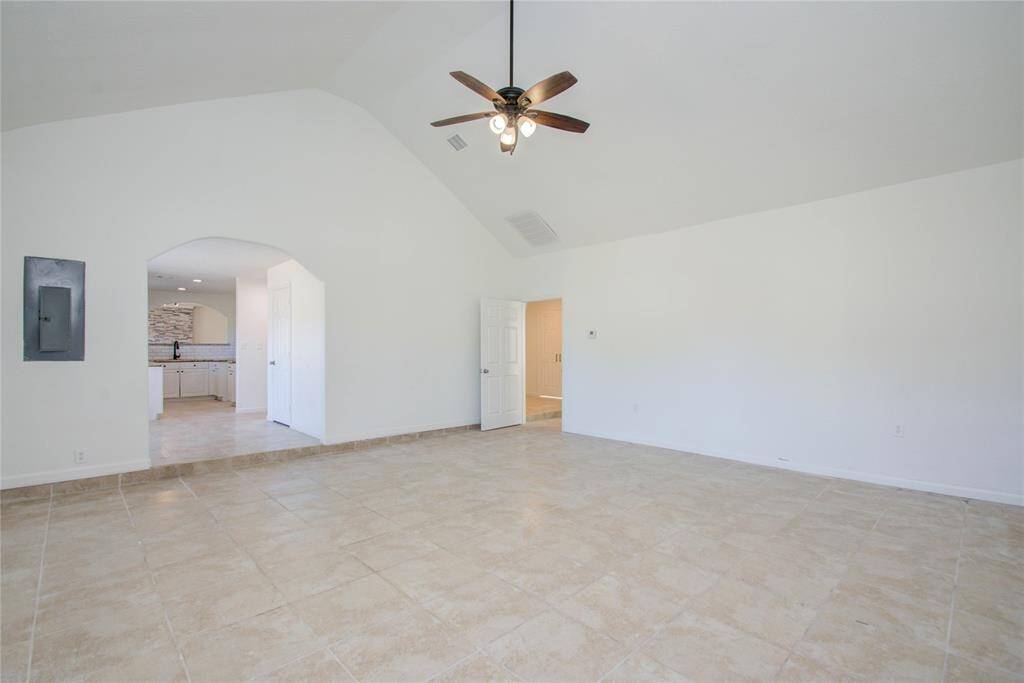 View from main side entrance into large living room area, dining room, and kitchen