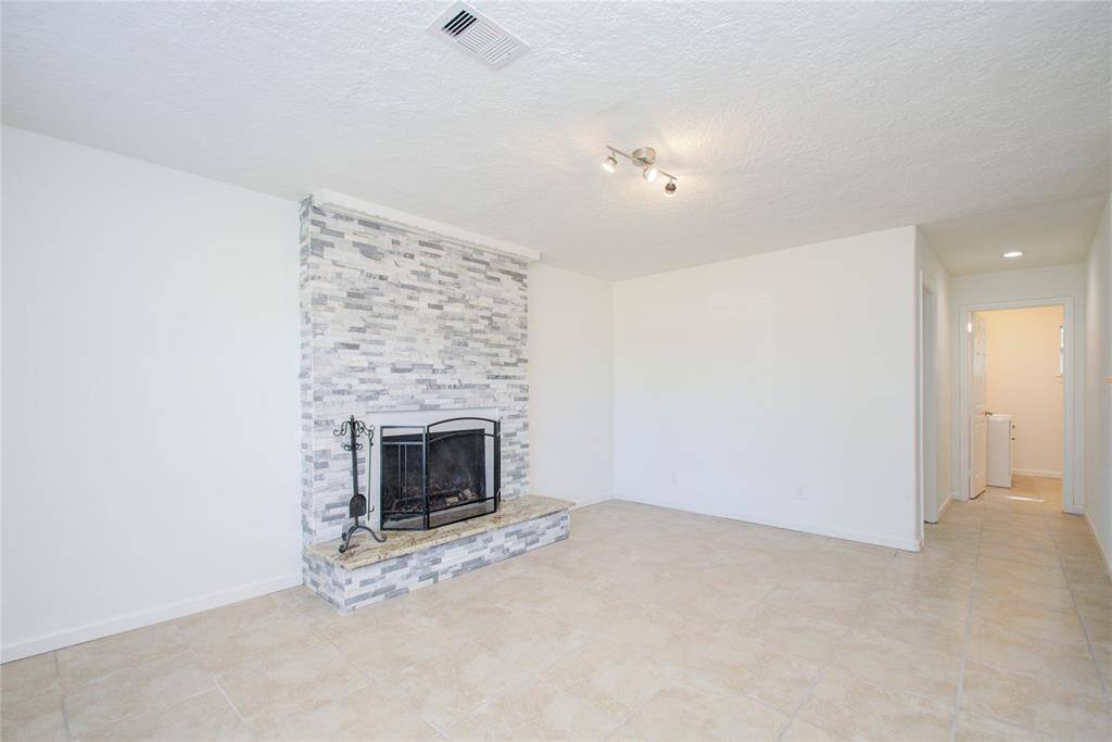 Second living room area and view into secondary bedroom and secondary downstairs bathroom