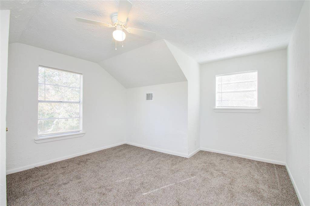 Another view of one of the upstairs secondary bedrooms with lots of light and new carpet