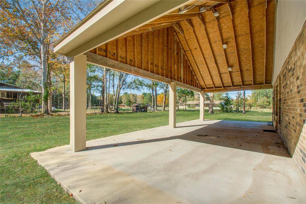 Another view of the large side porch from the large backyard