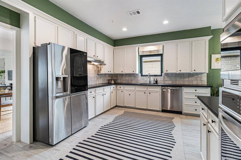 The kitchen just off the dining room has plenty of space for preparing meals on the quartz countertops and the electric induction cooktop speeds up the cook time