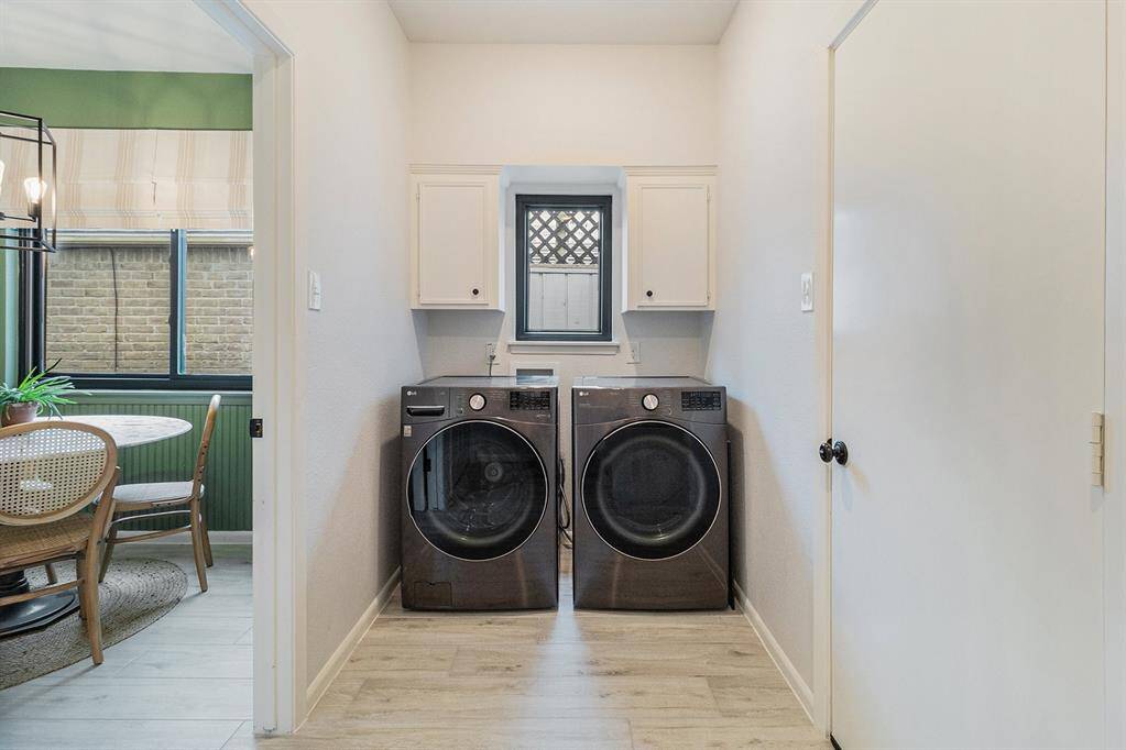 In house laundry room with storage.
