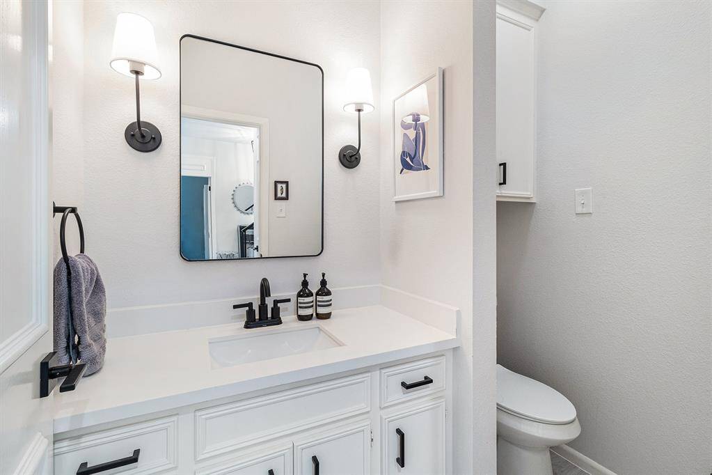 Half bath is tucked away from the main living area.