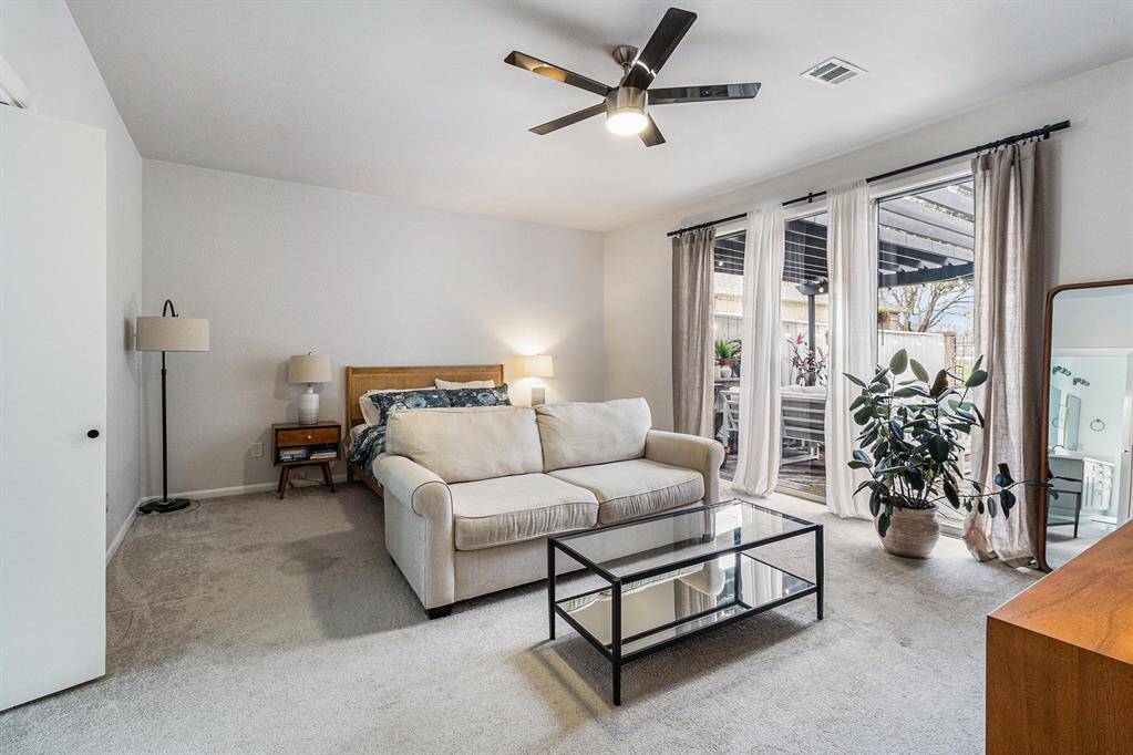 Spacious first floor primary bedroom with patio doors on to the ground floor deck and arbor.