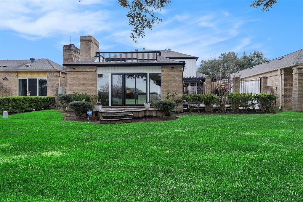 The back view of the home with the modern replaced windows and patio doors.