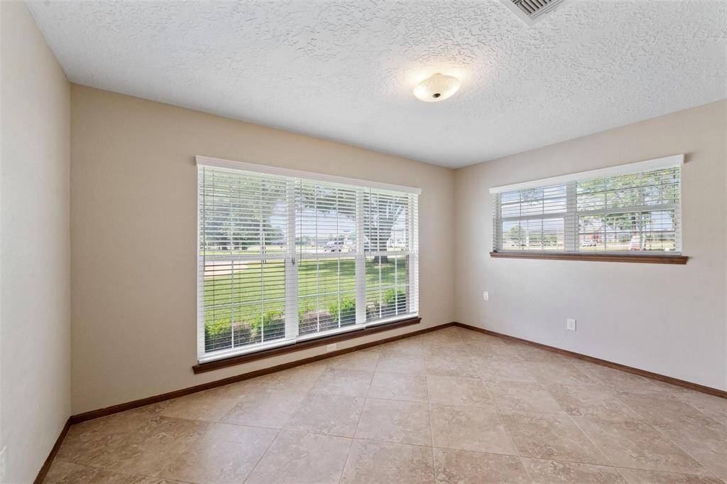 The second bedroom features a massive window that allows plenty of natural light to filter through.