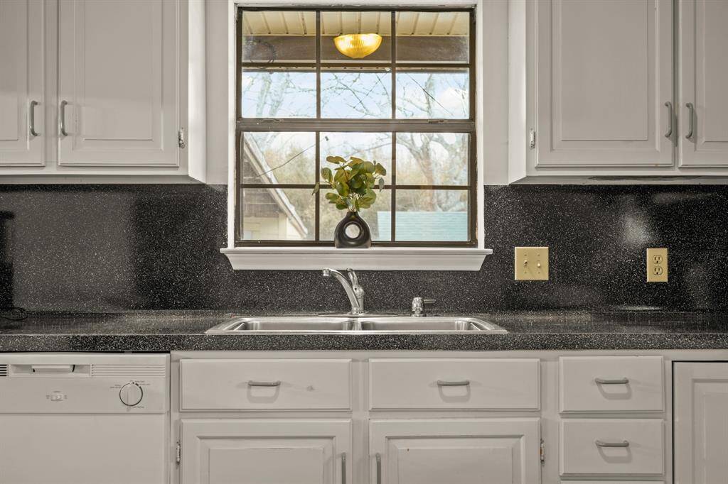 Laundry room with extra sink, storage cabinet and room for extra fridge.