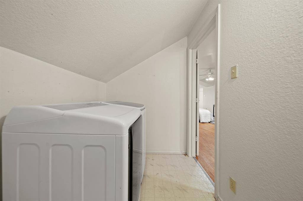 another view of upstairs laundry room with water heater.