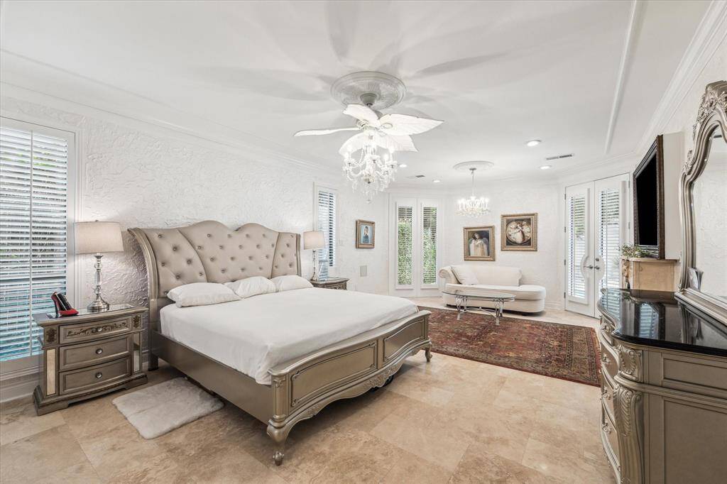 PRIMARY BEDROOM- Large primary suite with tile floors and ensuite bathroom.