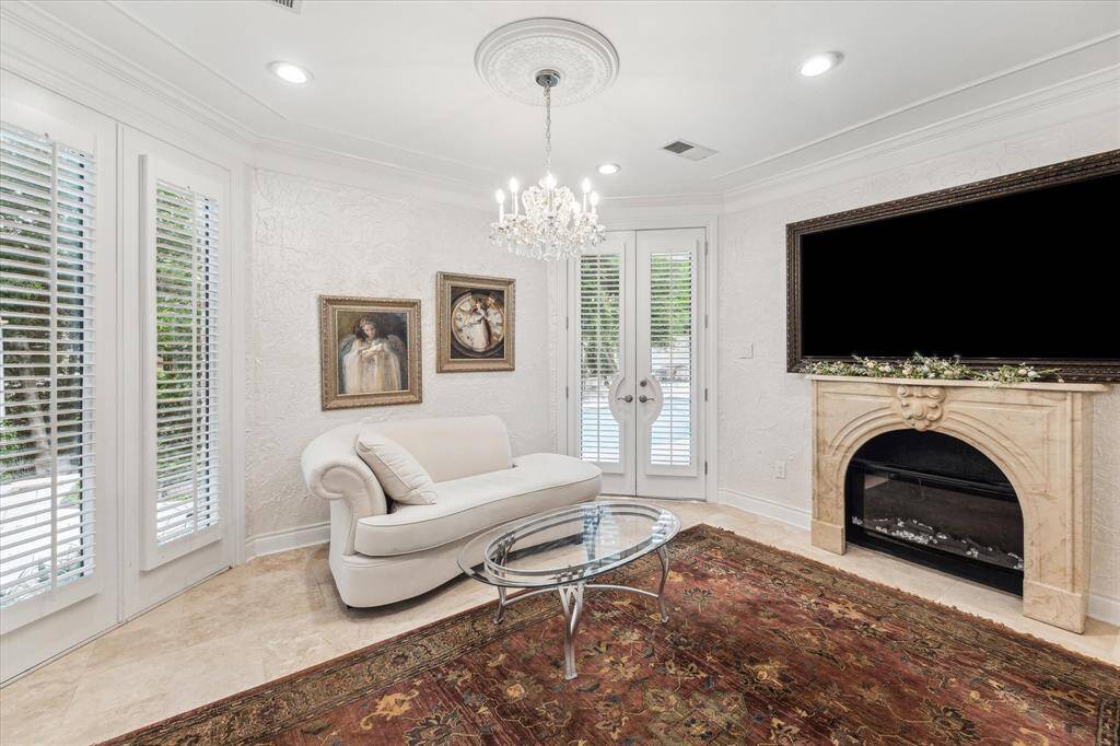 PRIMARY BEDROOM- Sitting area with electric fireplace and backyard access.
