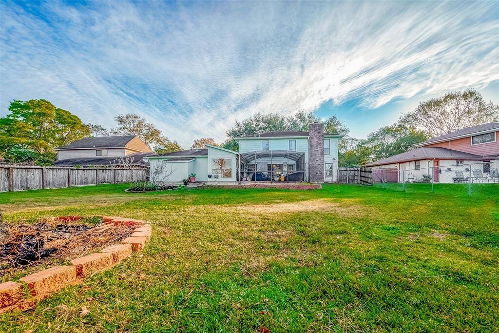 The expansive backyard offers plenty of room for outdoor activities, gardening, or simply enjoying the serene surroundings