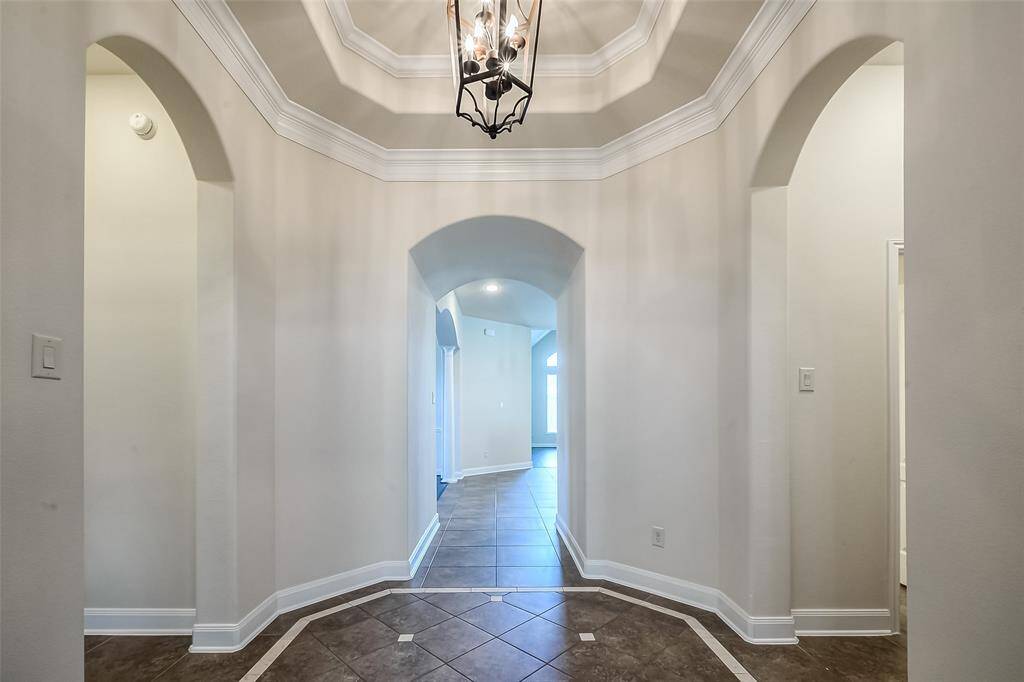Soaring rotunda with guest/mother in law suite to the left and half bath / mudroom to the right
