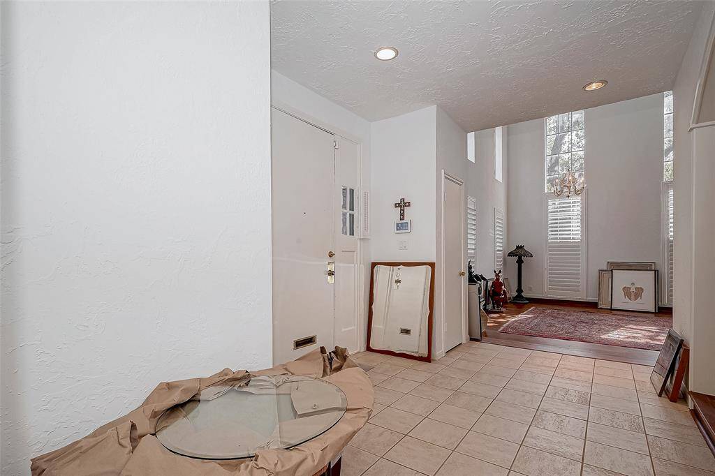 Tile foyer opens to living area and dining room