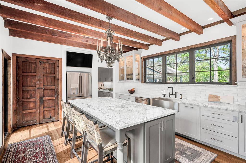 This magnificent kitchen is complete with Italian crafted backsplash, a Brizo Bridge faucet, "InSinkErator" hot & cold water dispenser, 36" apron ss sink, under & in cabinet lighting, and an aboundant amount of custom designed storage