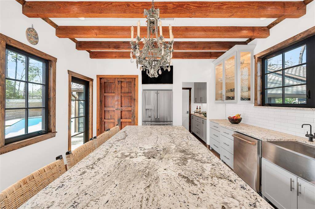 Enchanting Elegance describes this kitchen. Extra large gorgeous granite Island and Custom "Ram" Windows, which you will find throughout the entire home