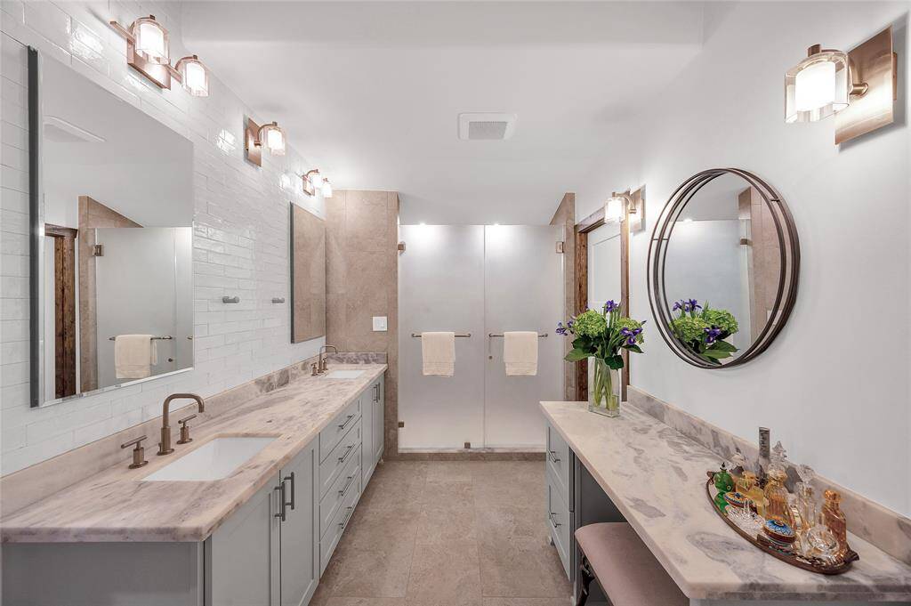 Second Primary bathroom with Italian glazed tile backsplash, large designer walk-in shower & double sinks featuring "Kohler Purist Collection" fixtures.  Also boasting mirrored Robern medicine cabinets with hidden electrical outlets. Spacious walk-in closet with dressing area & custom Elfa shelving not shown