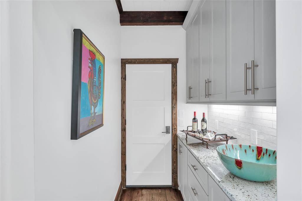 Perfect for entertaining this Butler's Pantry has a plentiful amount of storage.  This door leads to the private entrance into the guest house