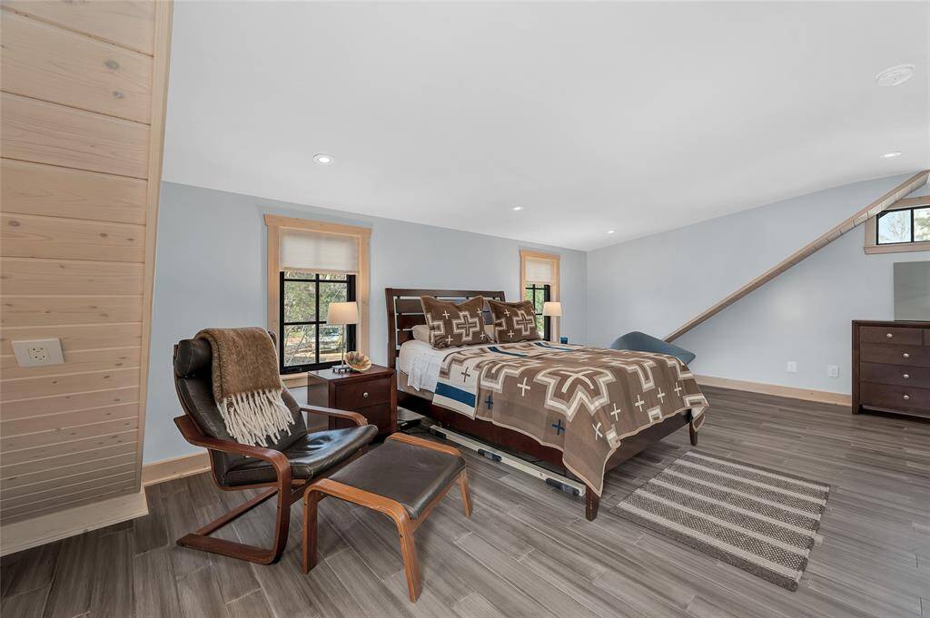Primary bedroom in the guest house includes custom lighting, a study nook, and lots of storage in the custom closet now shown