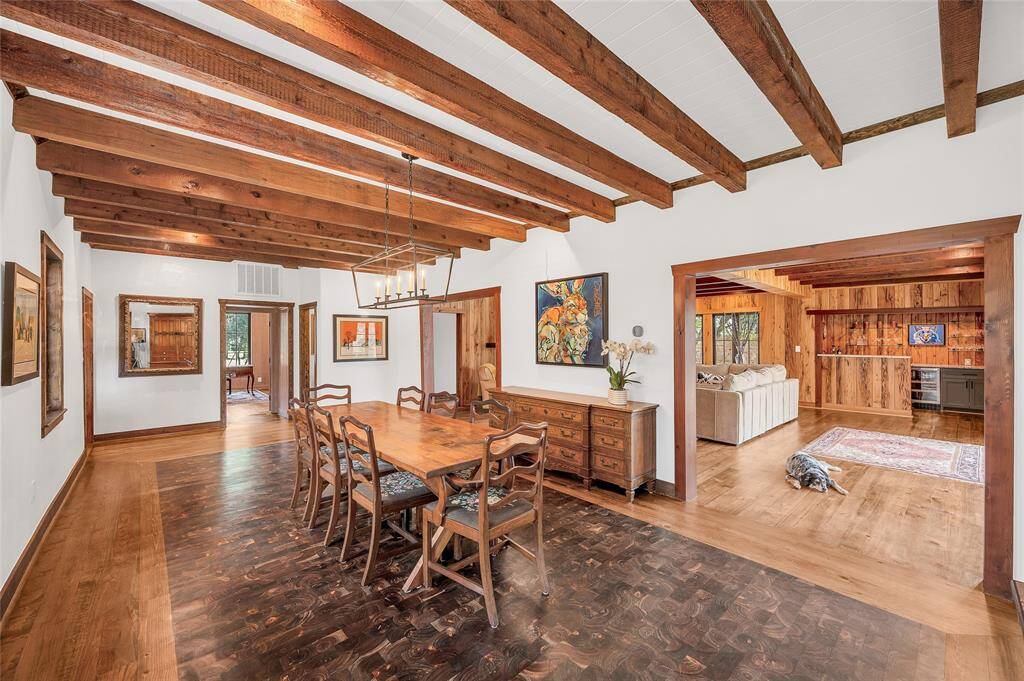 Dine with distinction in the large elegant dining room, boasting rough hewn cedar beams with custom crafted flooring