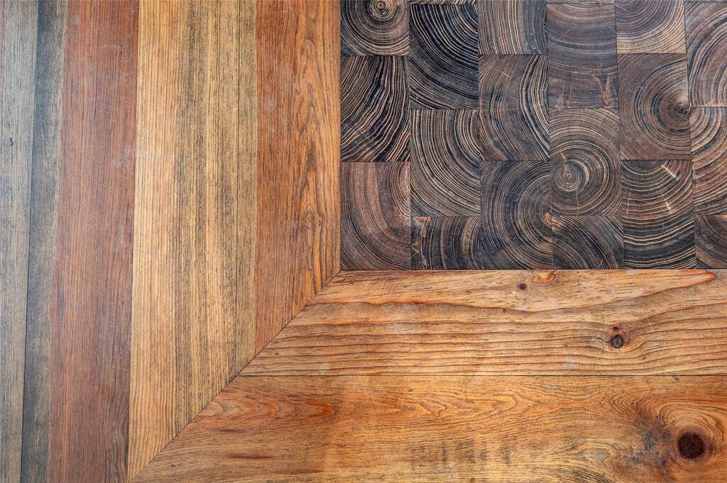 Exquisite handcrafted flooring in the dining room, old growth pine with inlayed endcut cypress blocks