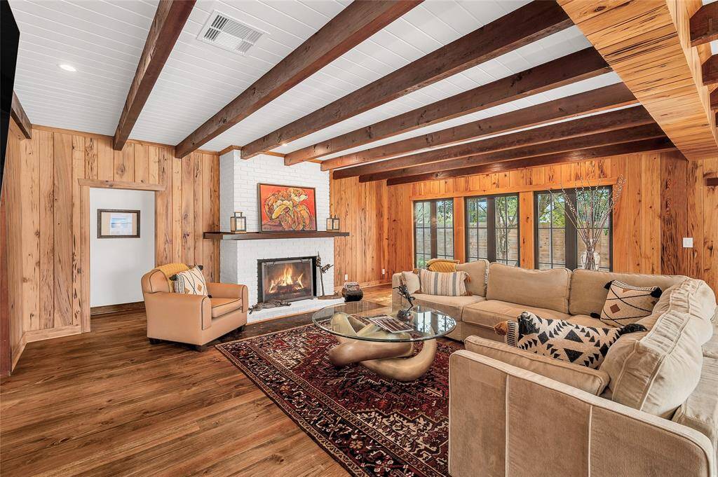 Enjoy this large living area with plenty of windows & glass doors, cedar beams artistically wrapped, and paneled pecky cypress walls. Every Plank Tells a Story!