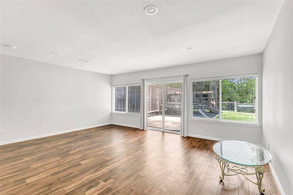 Primary bedroom with sliding glass doors and picture windows.