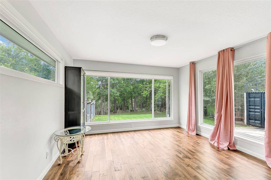 The bedroom has gorgeous views of the park like backyard.