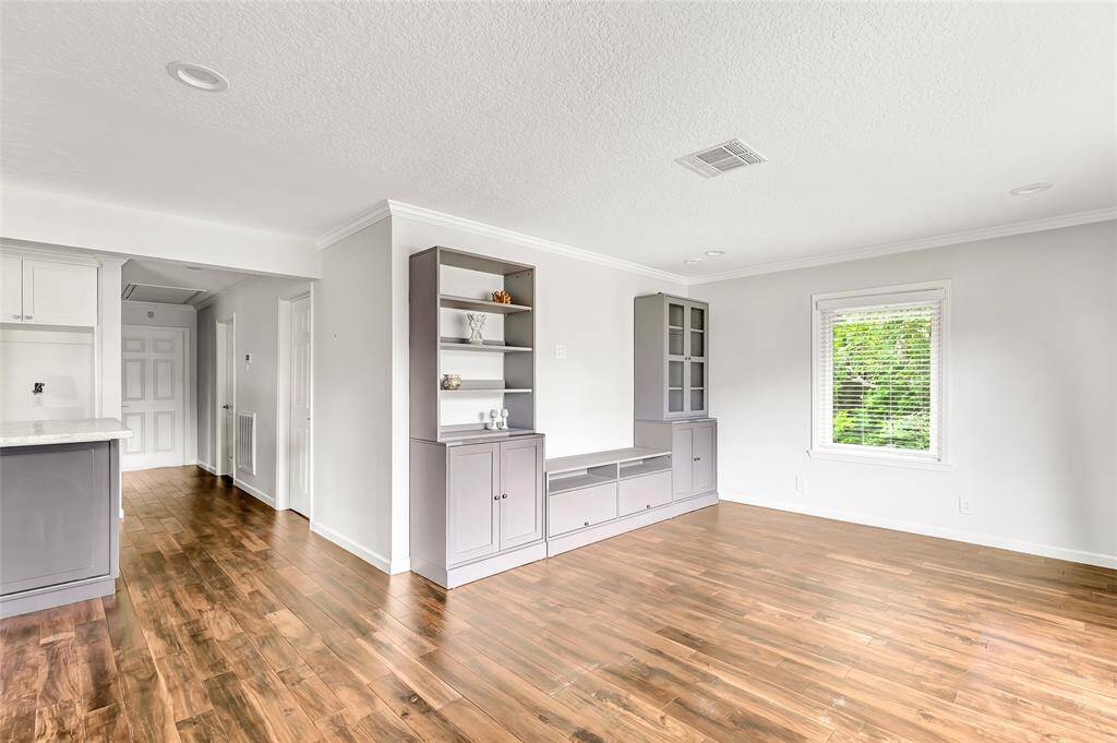When you enter the living room is to your right and the kitchen to your left.