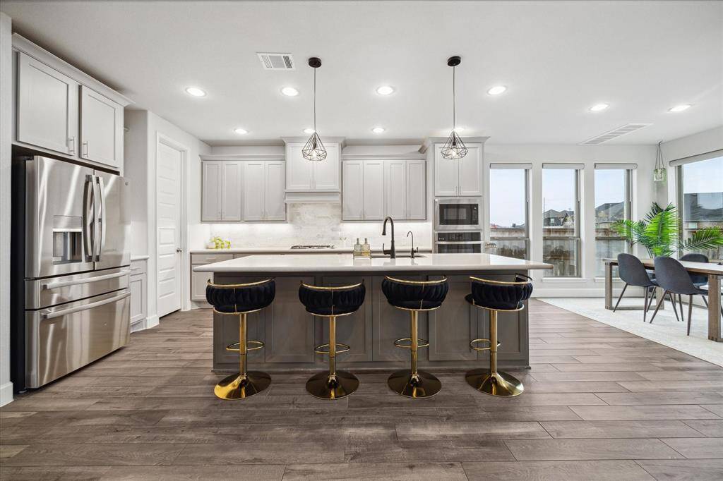 This spectacular chef’s kitchen is open to a casual dining area and the spacious den. The home has a reverse osmosis drinking water system.  The gorgeous Kitchen refrigerator can be included. The cabinets are upgraded --soft close cabinets.