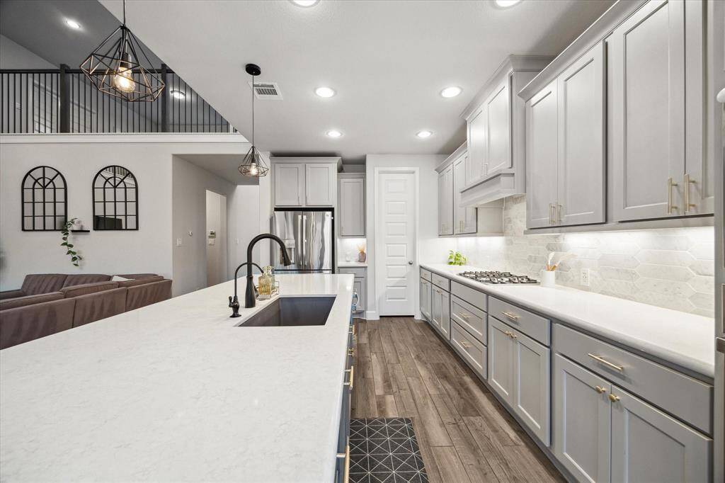 You will be inspired to entertain more often with this beautiful kitchen, featuring ample countertop space for effortless meal prep and cleanup. With an abundance of cabinetry and a spacious walk-in pantry, there’s plenty of room for all your favorite kitchen gadgets.
