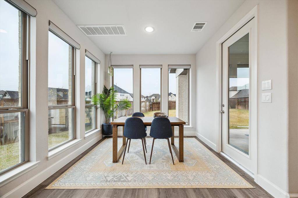 The casual dining area is filled with natural light, thanks to an abundance of windows.  It is very handy to the kitchen.