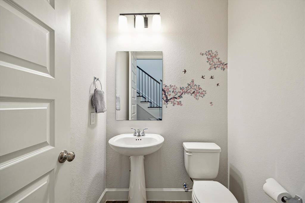 A lovely powder room, conveniently located downstairs, offers added comfort and convenience for both residents and guests.
