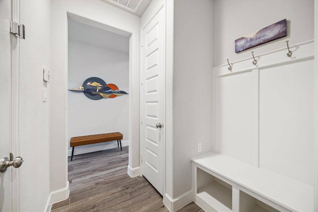 A convenient mudroom, located just inside the garage entry, helps keep everyone organized which helps to promote a tidy home.
