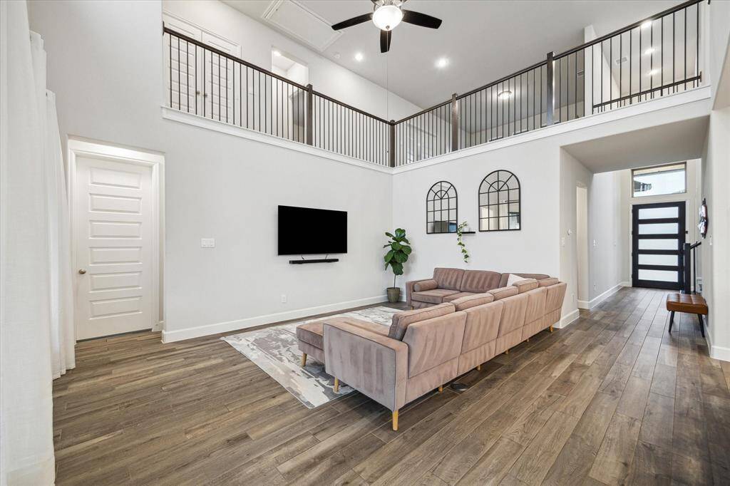 The two-story den is both spacious and inviting, offering an open feel with plenty of room for relaxation and entertaining.