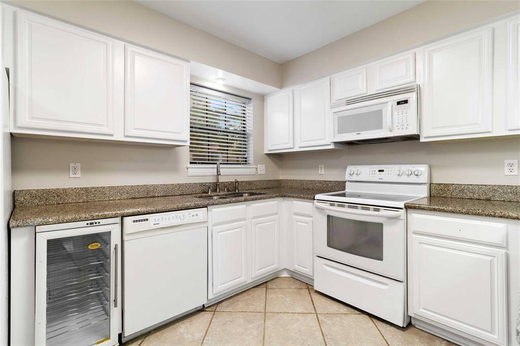 There's a window above the sink for natural light and tile flooring throughout.
